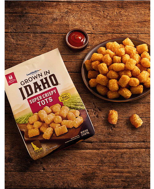 Plate of tots on wooden table.